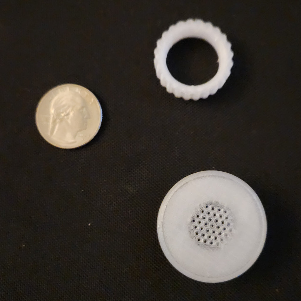 7/8 inch tub vent and its nut next to a US quarter for size